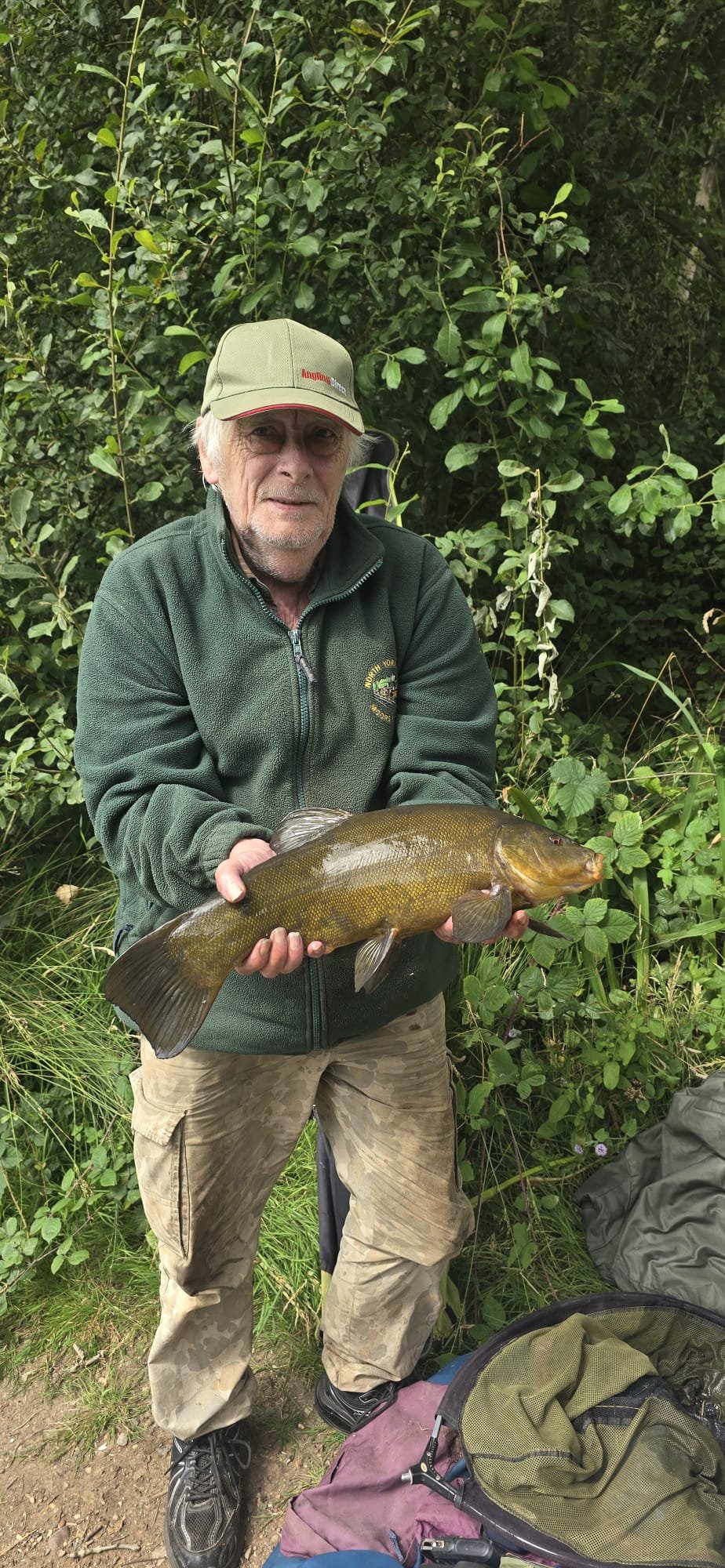 Angler holding a fish at Kelsey Gardens